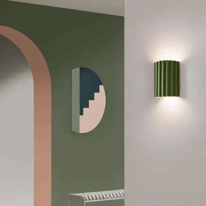 Unique modern wall sconce, artistic wave design. Contemporary LED lamp providing decorative home lighting.