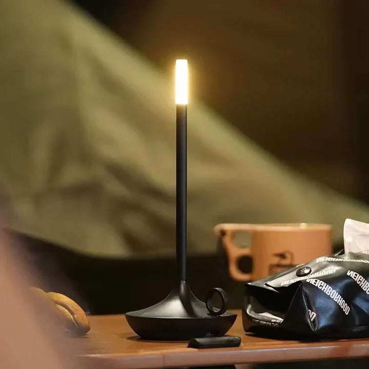 Modern dimmable rechargeable LED candle table lamp. Portable wireless ambient light for home decor.