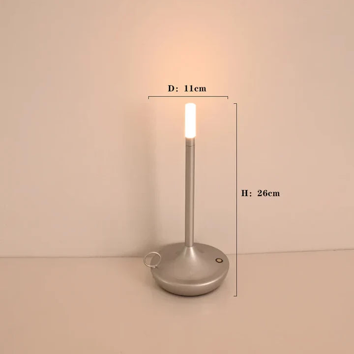 Dimmable LED candle table lamp, rechargeable & portable with touch control. Creates modern ambient light.