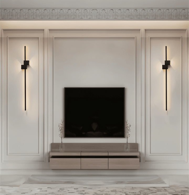 Vertical linear LED wall light providing ambient, modern lighting for a minimalist living space.