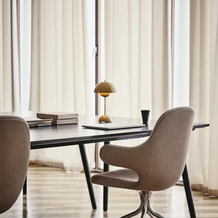 Close-up: Touch-sensitive base of a modern dimmable LumiTouch LED table lamp, sleek design.