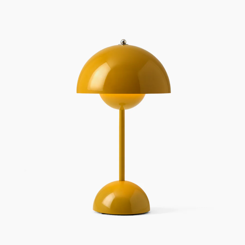 Modern LED table lamp casting warm ambient light in a living room, touch control functionality.