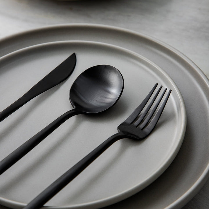 Matte silver flatware set beautifully arranged for a modern minimalist table.