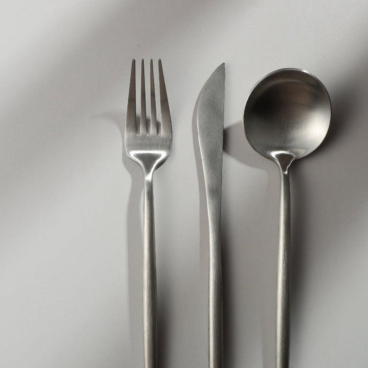 Matte silver flatware set, clean and modern for sophisticated dinnerware.