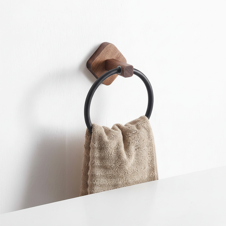Close-up of a wooden towel ring with a brushed aluminum wall mount. Highlights modern design and material quality.