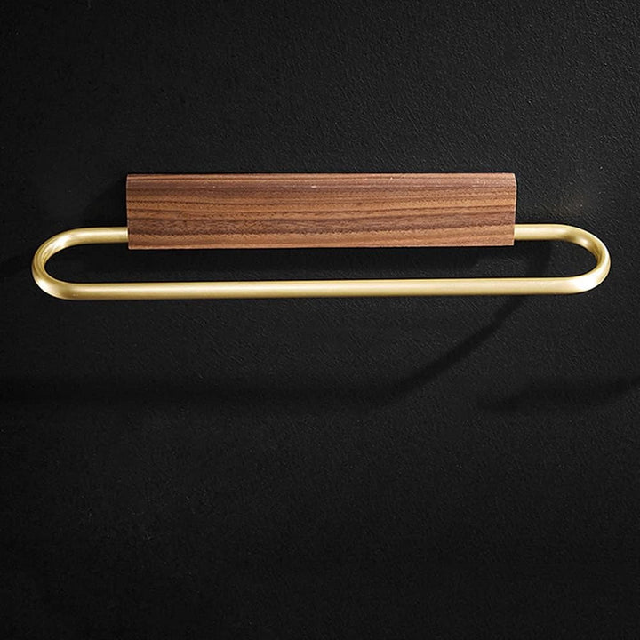 Wall-mounted modern walnut towel holder with brass detailing, ideal for organizing bathroom towels.