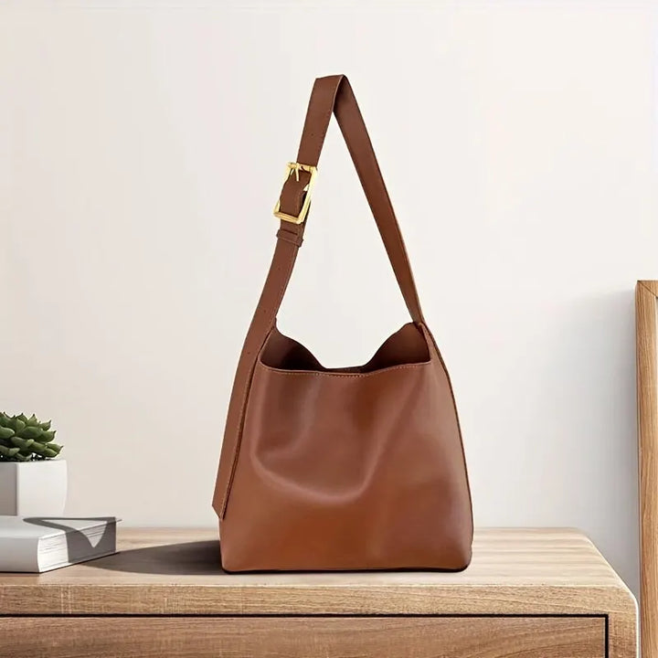 Modern women's shoulder bag in rich brown leather, perfect for everyday style & versatility.
