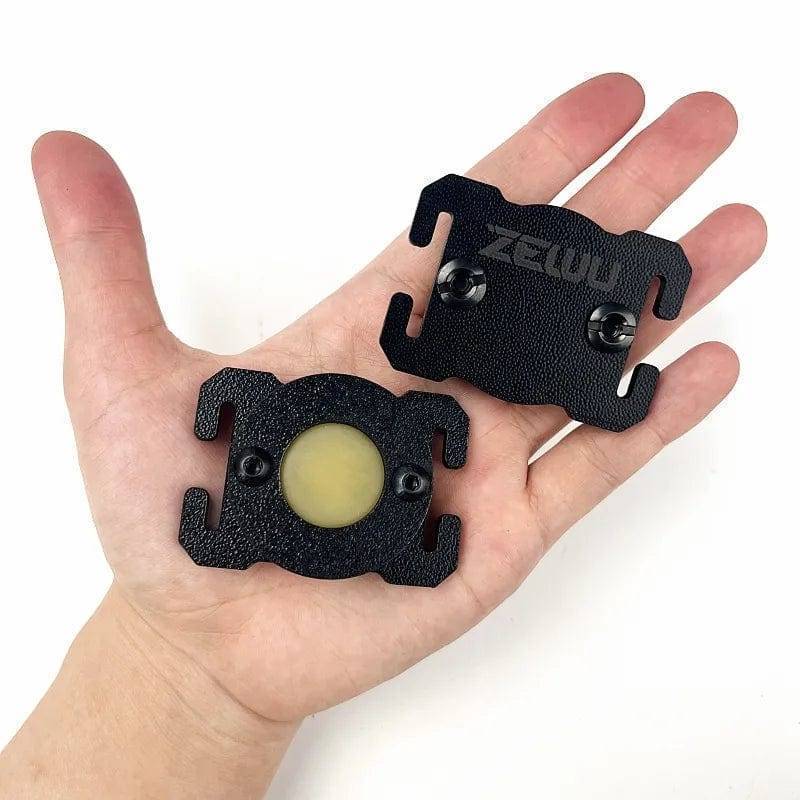 Black molle insect repellent pouch shown attached to a backpack, useful for camping mosquito protection