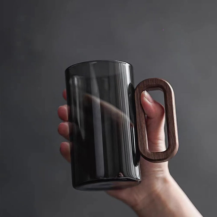Clear glass coffee mug with mountain base. Perfect for tea, coffee, and home decor. Unique kitchenware gift.