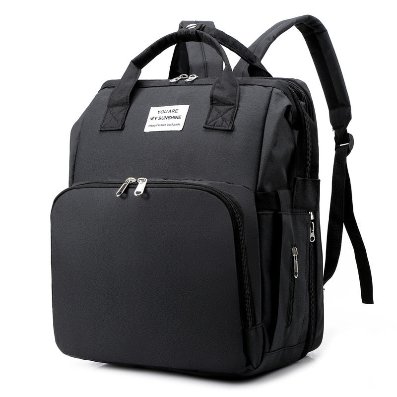 Multi-function portable baby bed & diaper bag travel backpack for parents on the go.