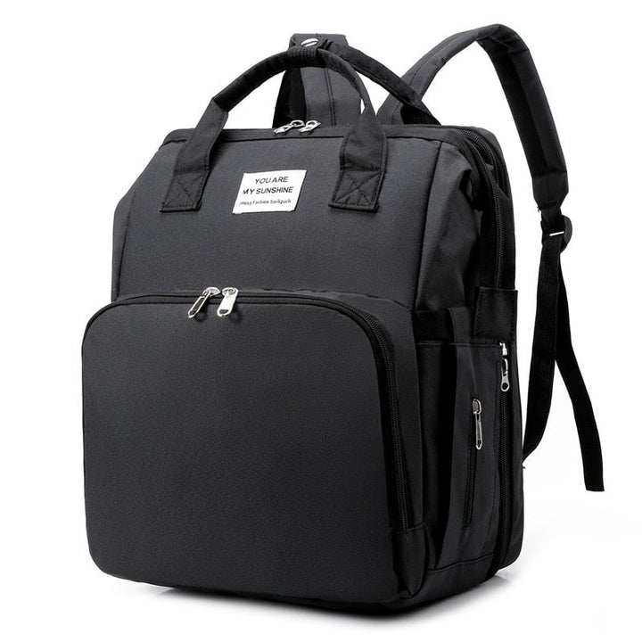 Multi-function portable baby bed & diaper bag travel backpack for parents on the go.
