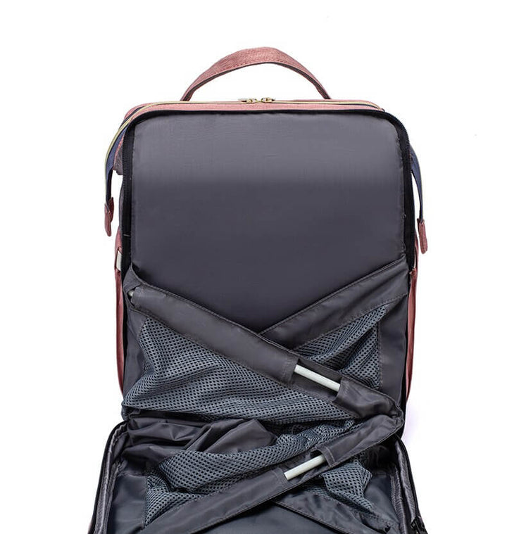 Interior view of multi-compartment nappy bag & travel backpack with portable bed.