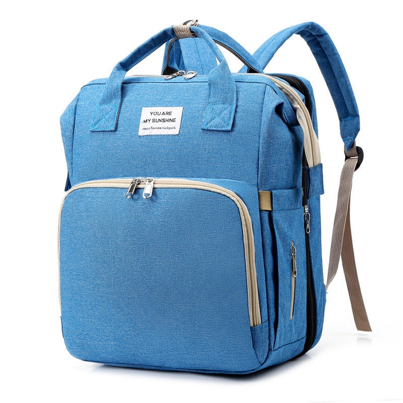 Foldable baby travel bed and nappy bag backpack, perfect for naps anywhere.