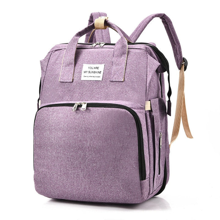 Versatile travel backpack for babies, converts to a comfortable portable bed.