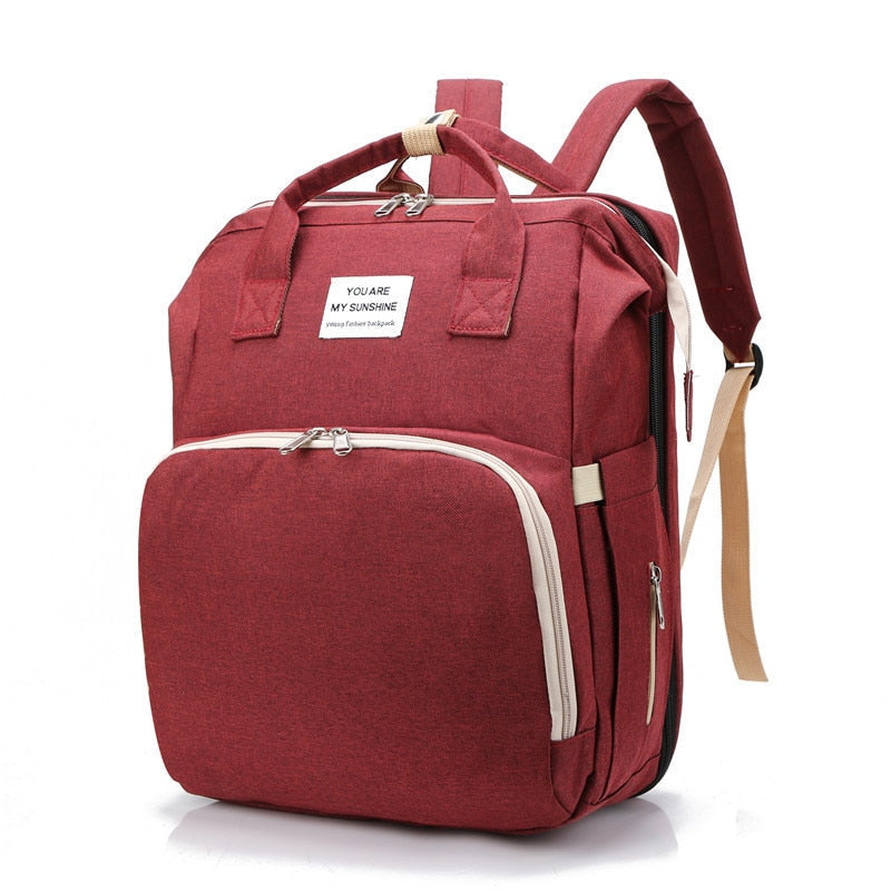 3-in-1 portable baby bed, diaper bag, & travel backpack for busy parents.