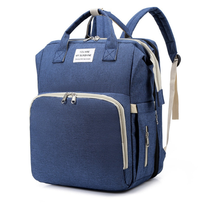 Convenient changing station and nappy bag built into a stylish travel backpack.