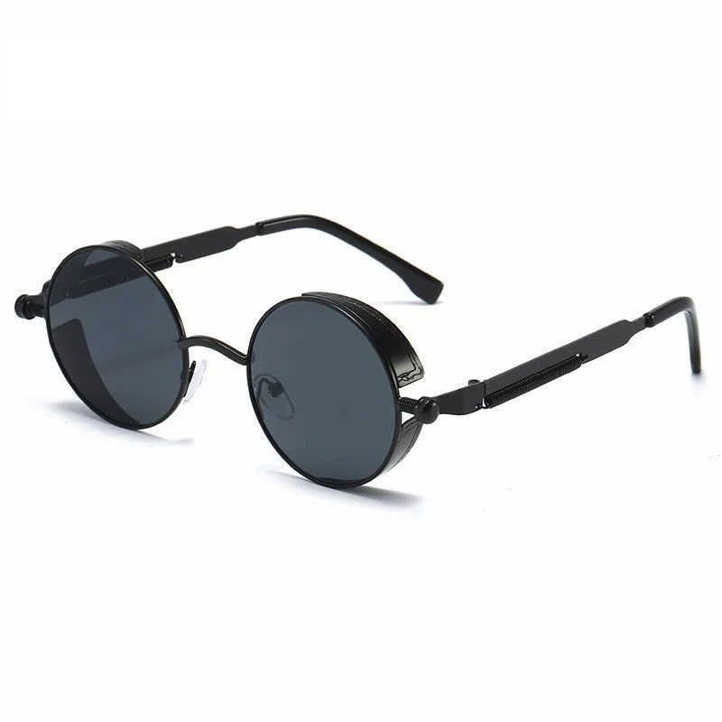 "Occhiali da sole vintage rotondi unisex con montatura robusta, colore nero grigio, protezione UV400, stile senza tempo."