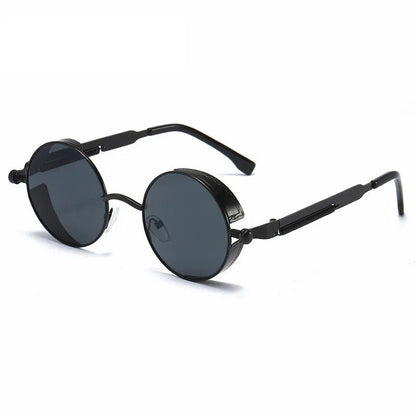 "Occhiali da sole vintage rotondi unisex con montatura robusta, colore nero grigio, protezione UV400, stile senza tempo."