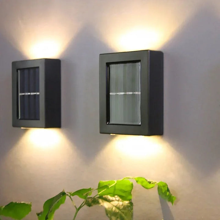 Durable black wireless solar LED wall light providing automatic outdoor garden and patio illumination.