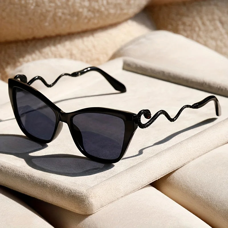 Women's oversized cat-eye sunglasses with detailed snake arms, perfect for sun protection.