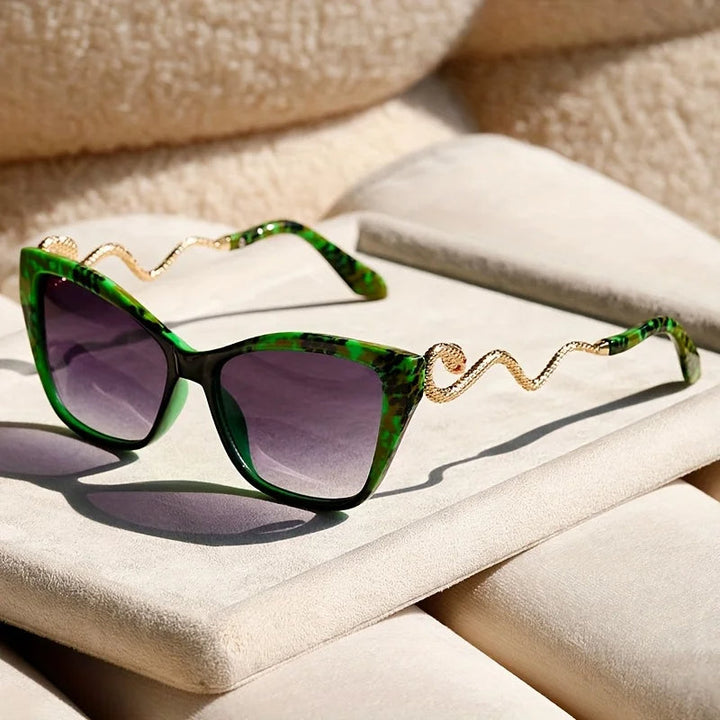 Eye-catching women's oversized cat-eye sunglasses with golden snake arm accents.