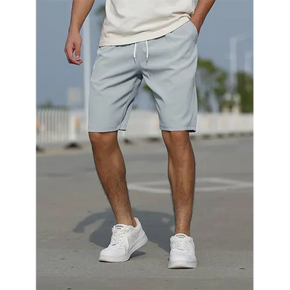 "Pantaloncini uomo vita alta blu navy traspiranti, adatti per l'estate, con design aderente e stile moderno."