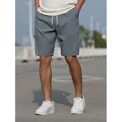 "Pantaloncini uomo vita alta blu navy traspiranti, adatti per l'estate, con design aderente e stile moderno."