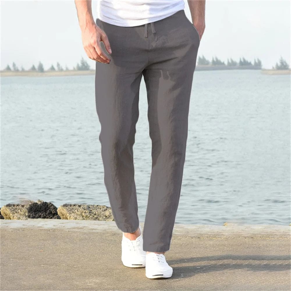 "Pantaloni uomo cotone lino traspirante, vestibilità rilassata, cintura regolabile, tasche, colore blu navy eleganti."