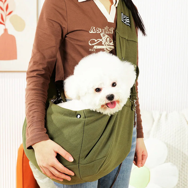 Pet sling carrier for small dogs & cats with adjustable strap. Comfortable & secure for pet travel.