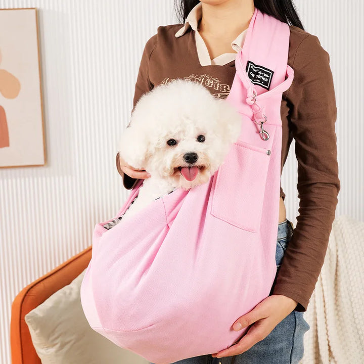 Secure pet sling carrier featuring a safety hook & adjustable strap for safe and comfortable small dog travel.