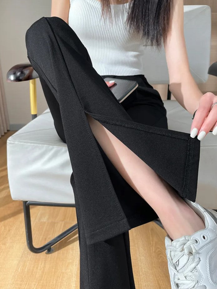 Chic black plus size high waist flared pants for women with trendy leg slits. All-year versatile apparel.