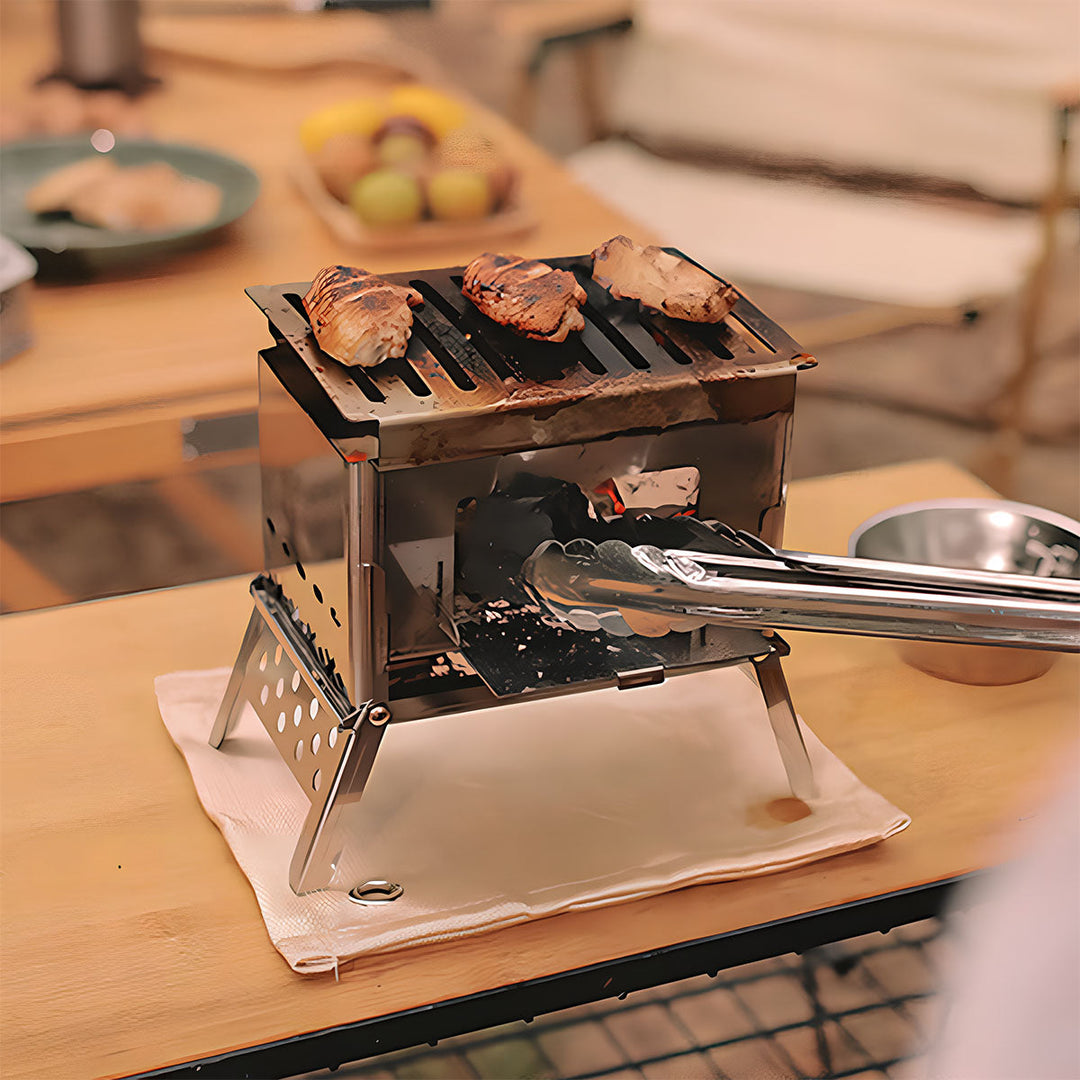 Portable camping wood stove and grill set up in a campsite, ready for an outdoor cooking experience.