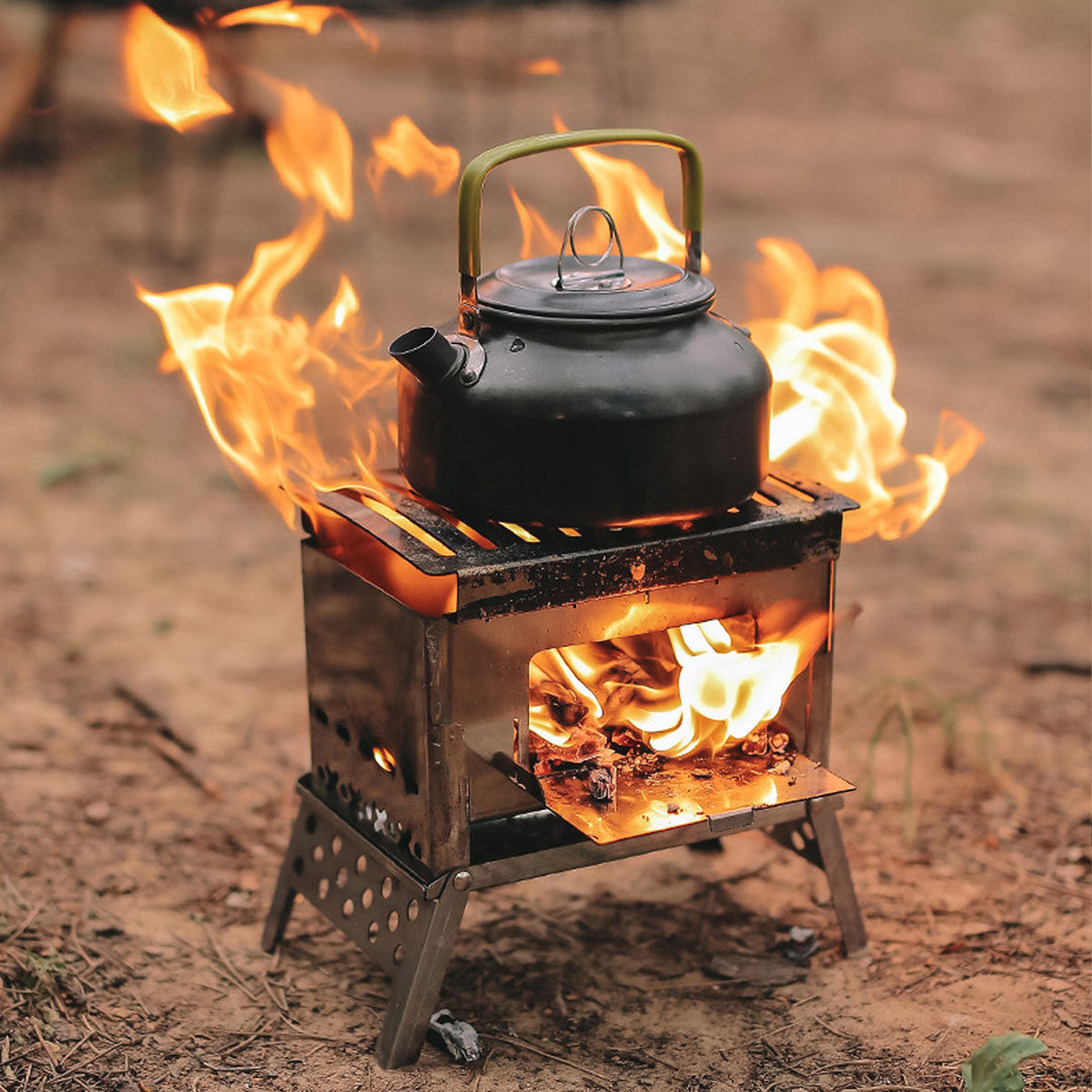 Survival gear: portable wood burning camp stove in a natural outdoor setting, ready for cooking.