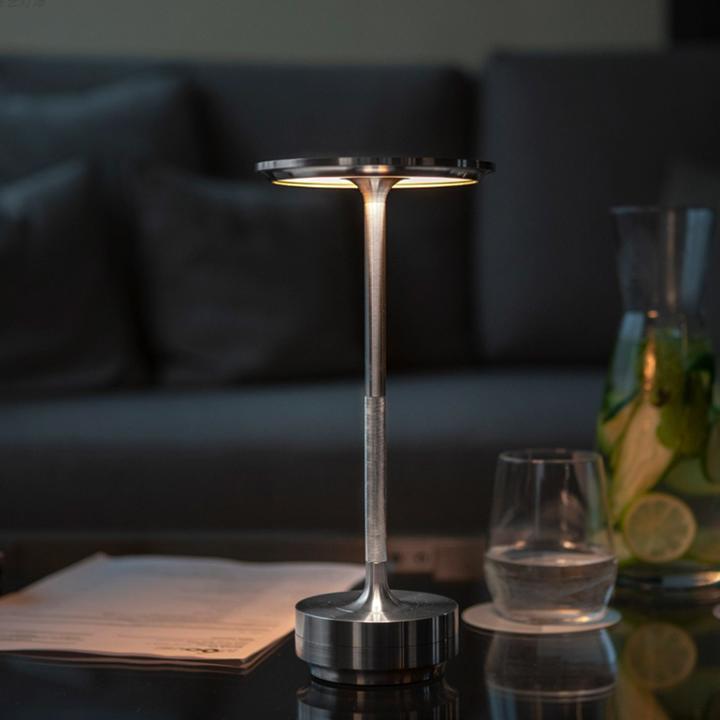 Sleek metal portable lamp with dimmable LED, perfect for any surface.