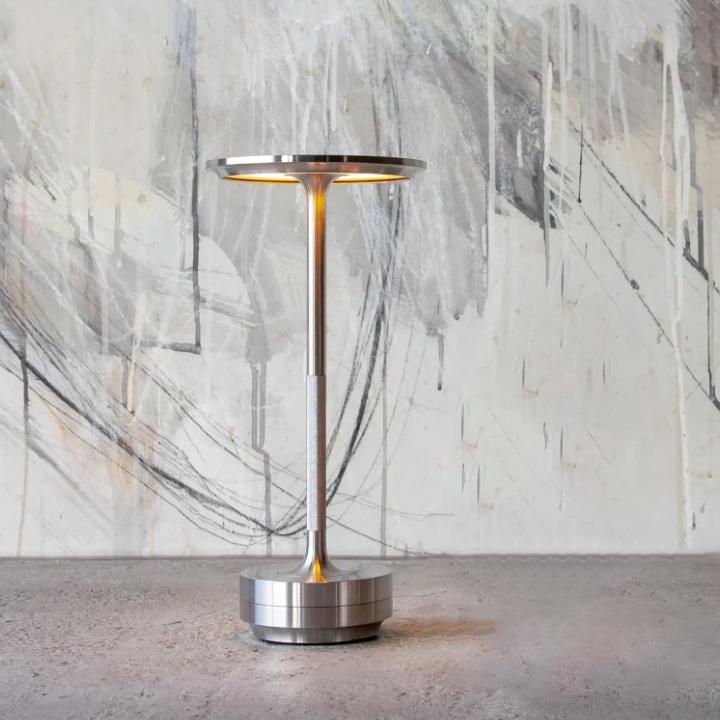 Rechargeable table lamp, offers flexible cordless lighting with adjustable brightness.