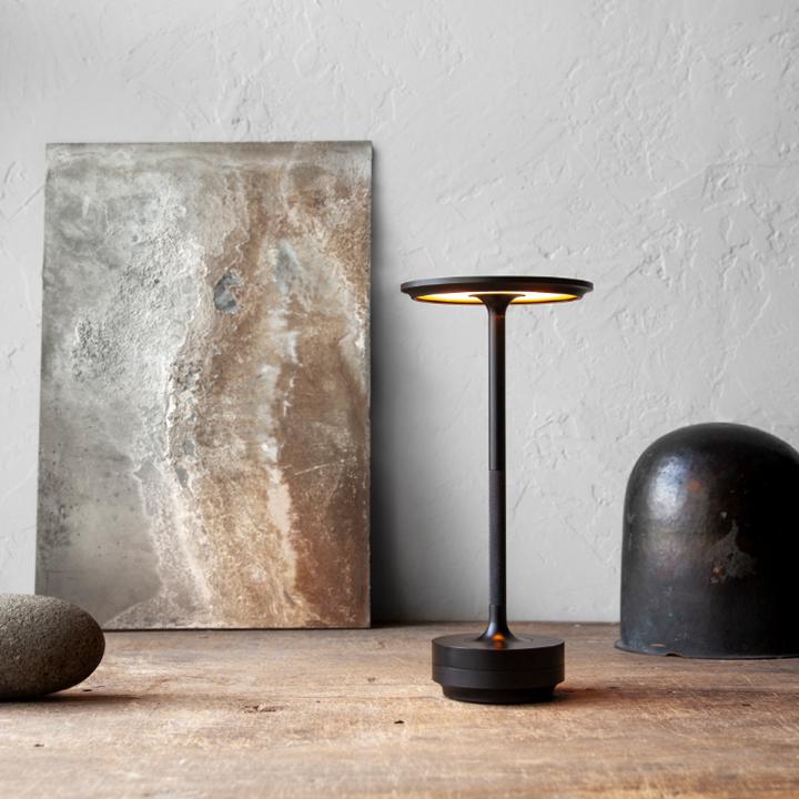 Cordless table lamp featuring adjustable light intensity, great for reading or dining.