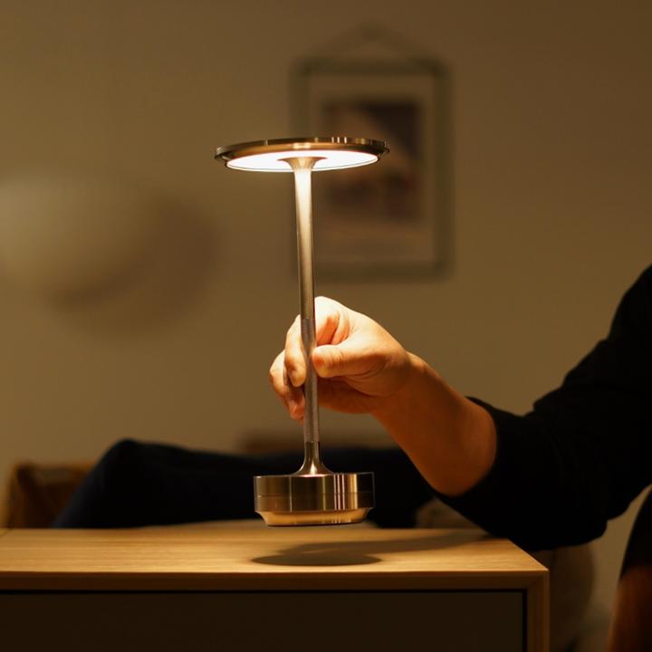 Energy-efficient dimmable table lamp, cordless design for modern homes.