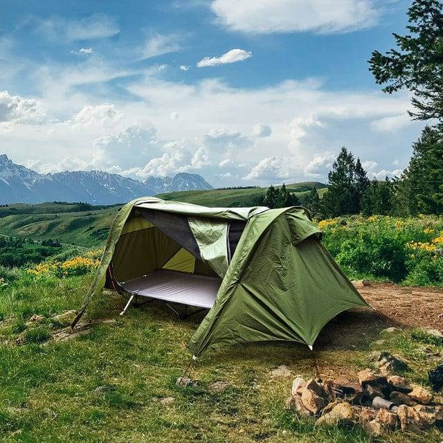 Unisex portable tent cot for camping, providing elevated shelter and comfortable sleeping.