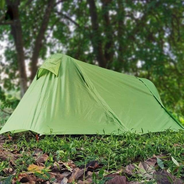 Portable elevated camping tent cot with integrated rainfly, offering outdoor shelter and comfort.