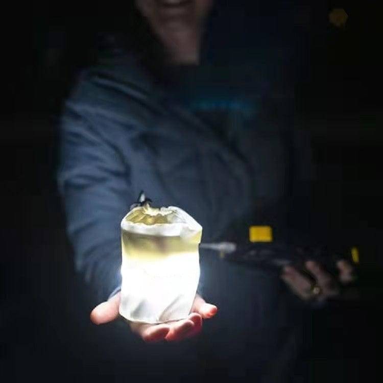 Inflatable LED lantern, USB-rechargeable, with charging cable, highlighting eco-friendly and convenient power.