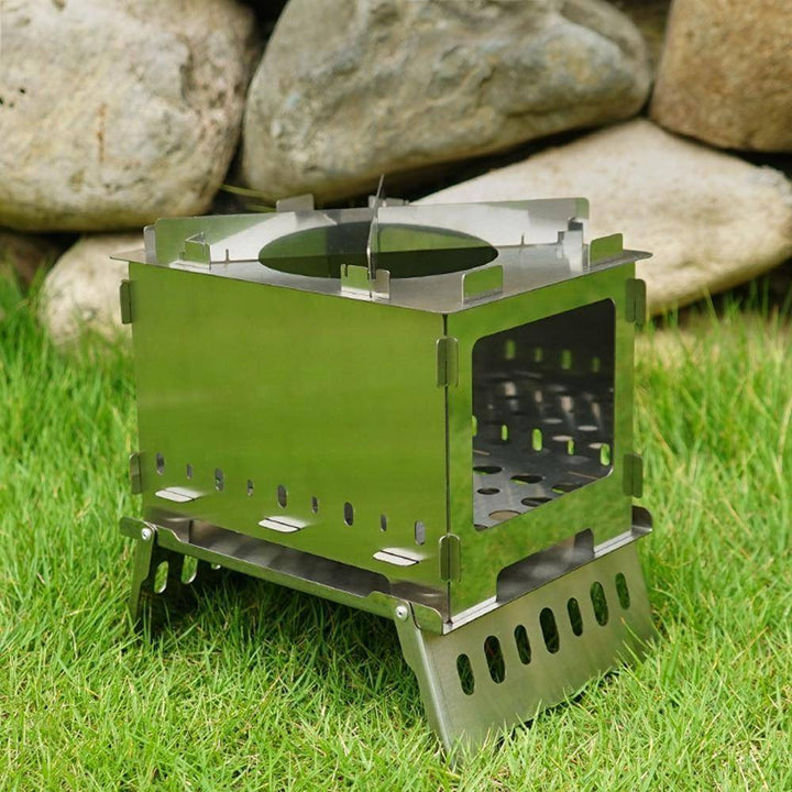 Portable stainless steel camping BBQ grill and wood stove, ideal for outdoor cooking and survival.