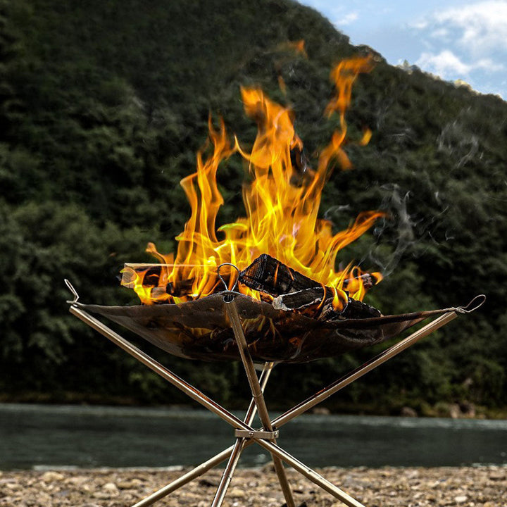 Outdoor campfire pit with grill rack, stainless steel construction for durability during camping trips.