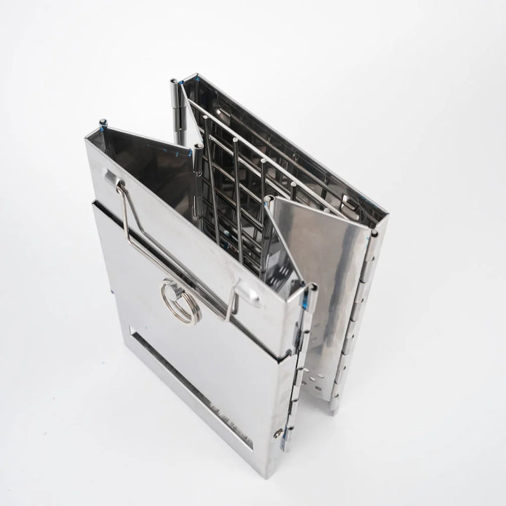 Stainless steel folding wood stove for camping, offering compact and reliable outdoor cooking