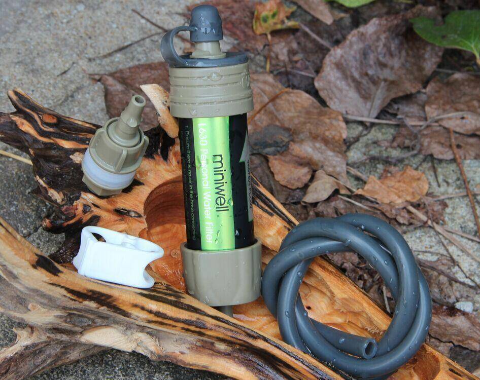 Portable survival water filter straw for camping & hiking, removing bacteria & protozoa from outdoor water.