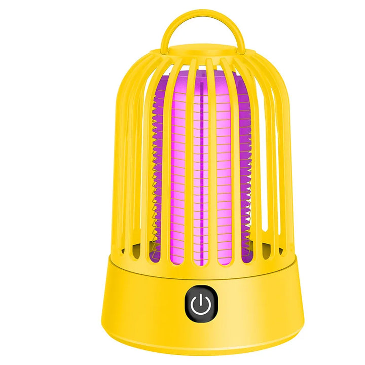 Travel-friendly UV mosquito trap beside a tent, demonstrating its use as a camping accessory.