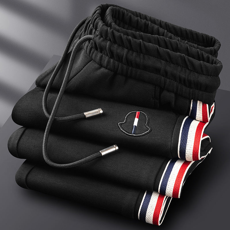 Man in a premium quarter-zip jogging suit from side view, comfortable for dynamic movement.