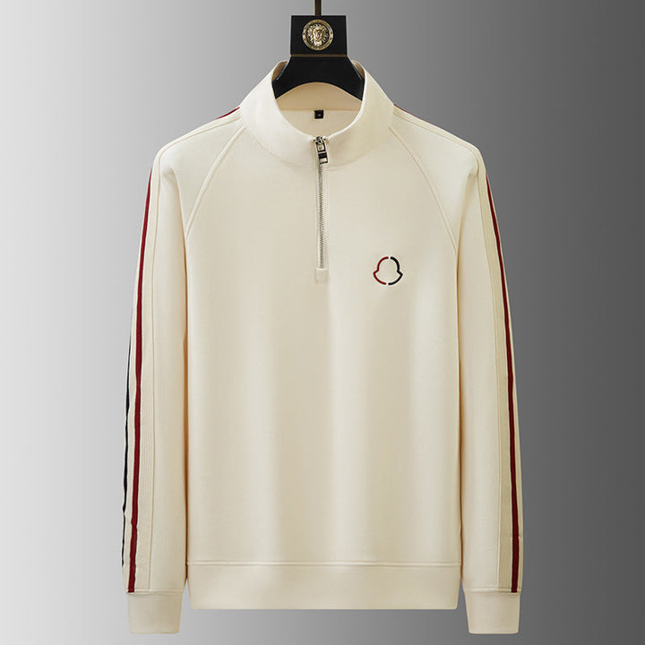 Men's premium quarter-zip athletic set worn for a casual day out, combining comfort & style.