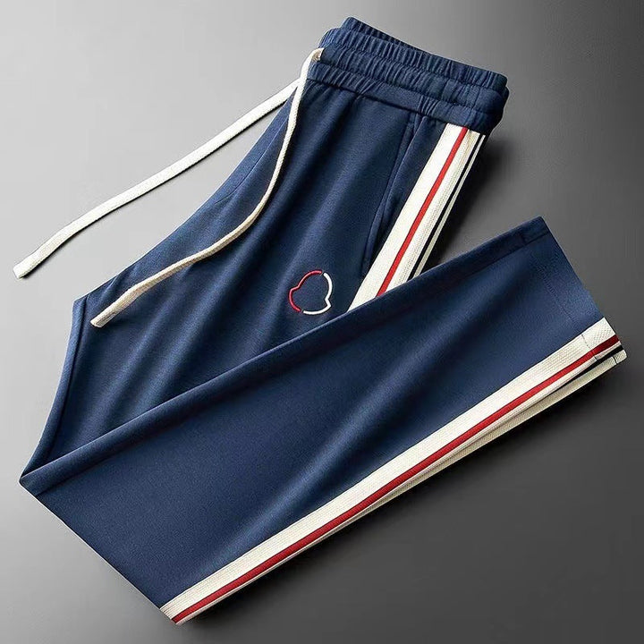 Fashionable men's sportswear set: a premium quarter-zip top with matching track pants.