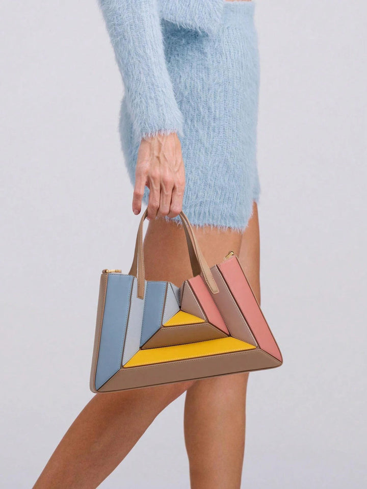 Elegant vegan leather sculptural handbag for women. Features a striking geometric design, perfect as a luxury statement piece.
