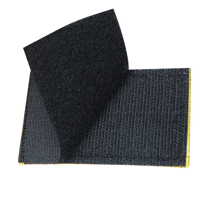 Close-up of a 'DO NOT PET' dog patch, hook and loop, high contrast for K9 communication